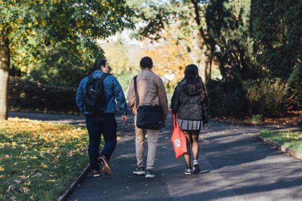 Three students walk through Botanic Gardens