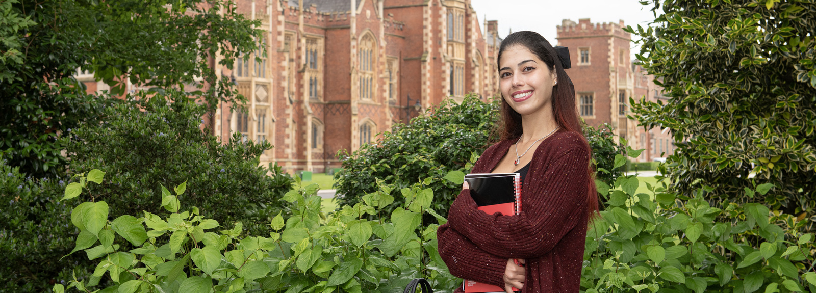 Student Brittany in front of Lanyon with textbooks