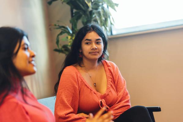 Student Diana talking to fellow students inside One Elmwood