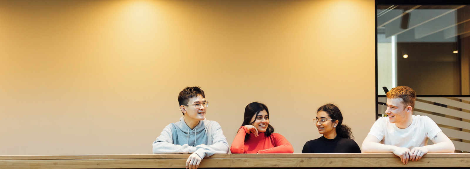 Four students at balcony in One Elmwood