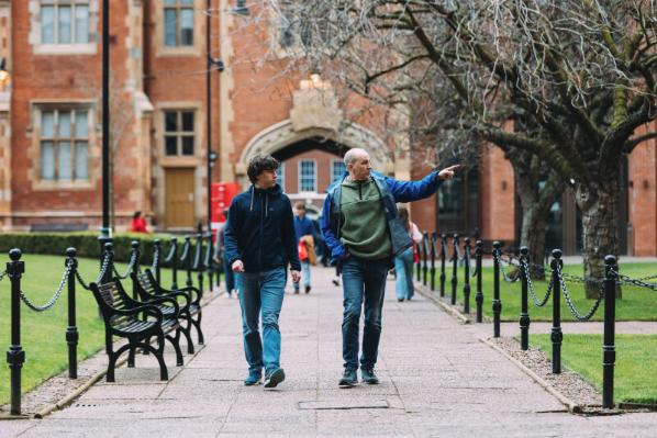 Parent and student walking through QUB Quad